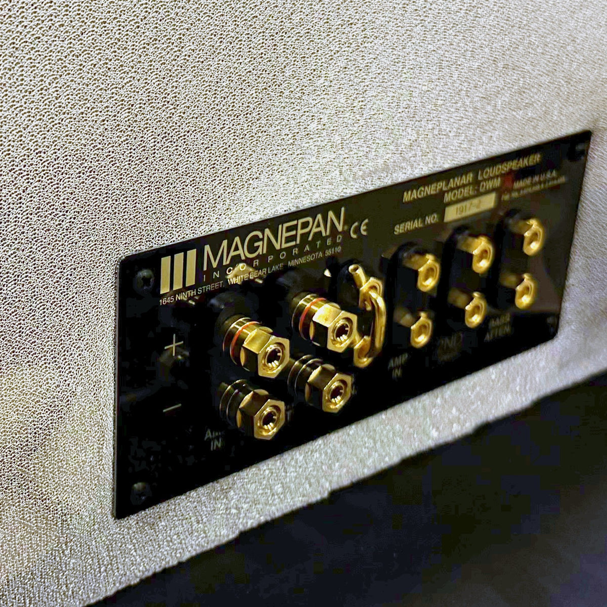 Magnepan DWMx Bass Panel, Off White, rear connection panel close-up showing the gold binding posts, amplifier input and bass attenuation terminals