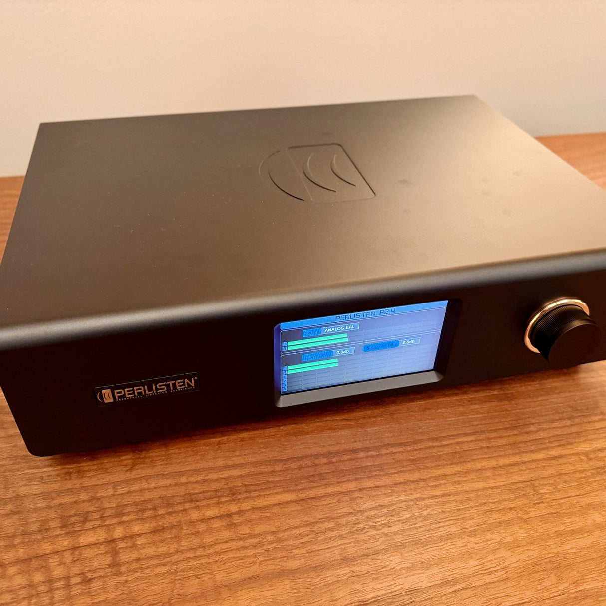 Perlisten DSPx Active Digital Crossover, Black, three-quarter front view from the left showing the embossed top panel