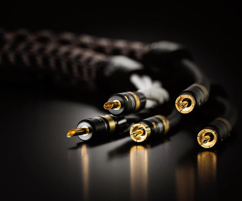 Viablue lifestyle photo with black background showing close up of T8 connectors on a HiFi interconnect