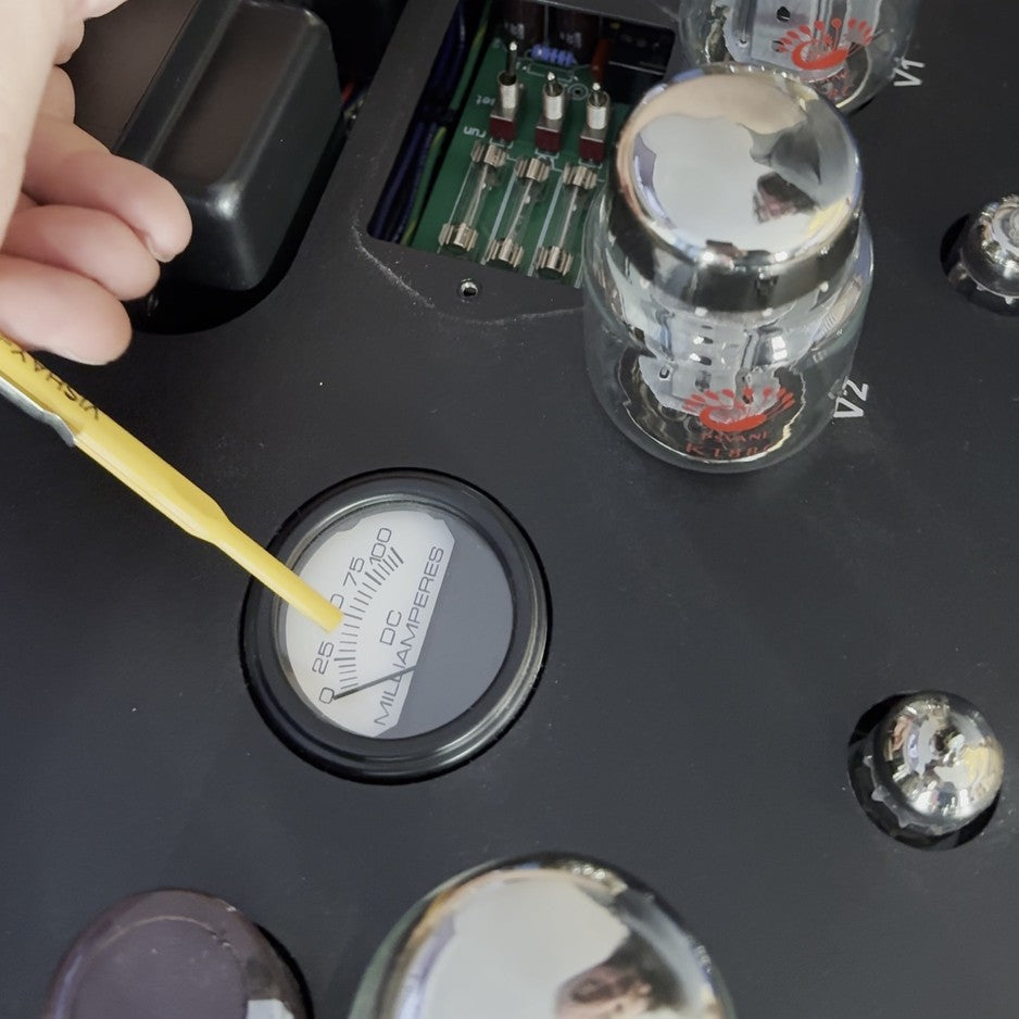 Bias screwdriver and DC milliamperes meter during a tube amplifier bias adjustment at The Listening Room