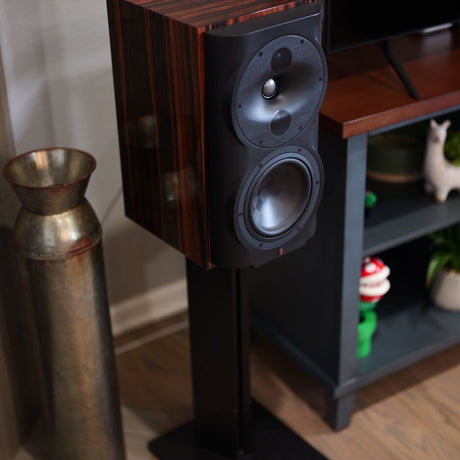 Perlisten S4b bookshelf speaker in High Gloss Ebony on speaker stand, full view in listening room setting
