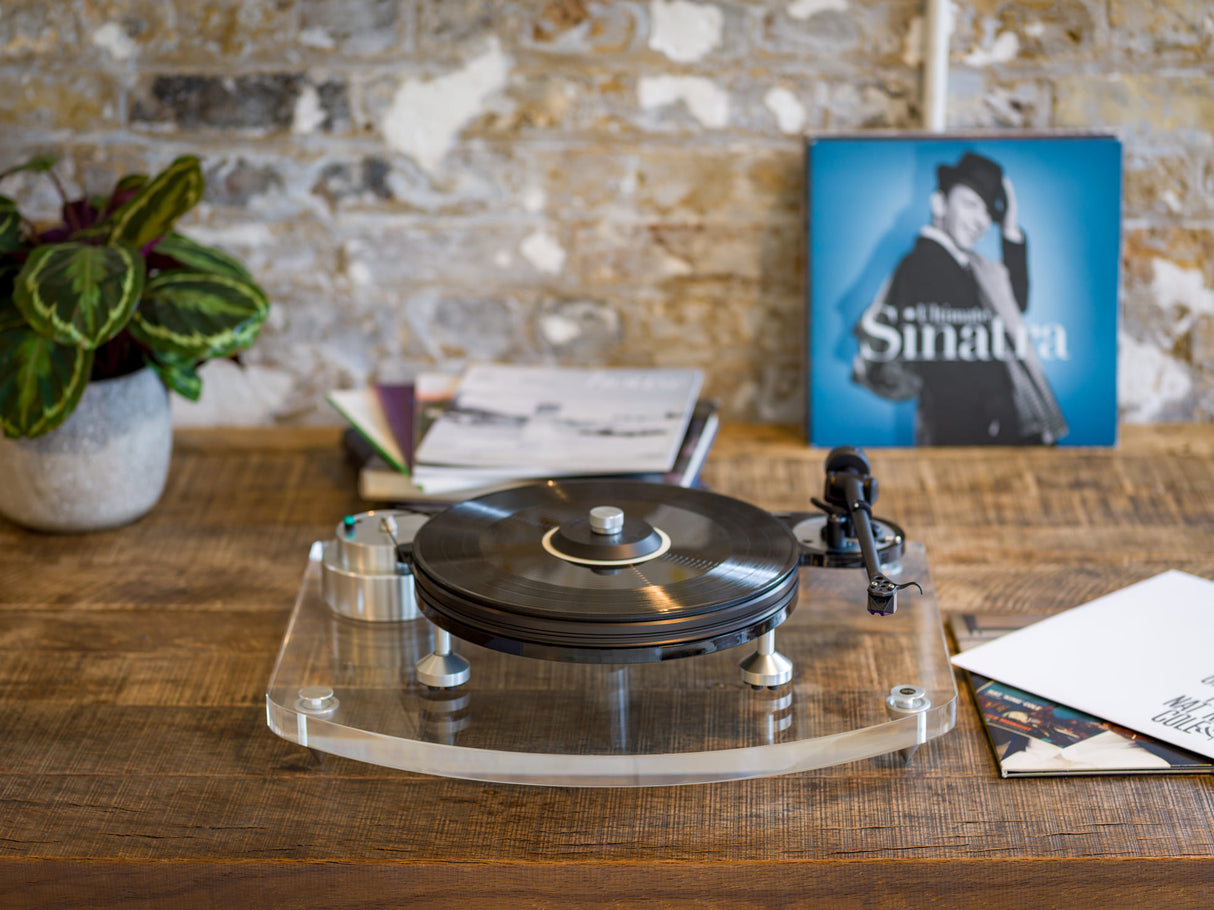 Michell TecnoDec Turntable with T2 Tonearm on a beautiful table with a frank sinatra record in the background