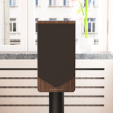Acoustic Energy AE300² in walnut veneer with grille on, on a stand in a modern living room