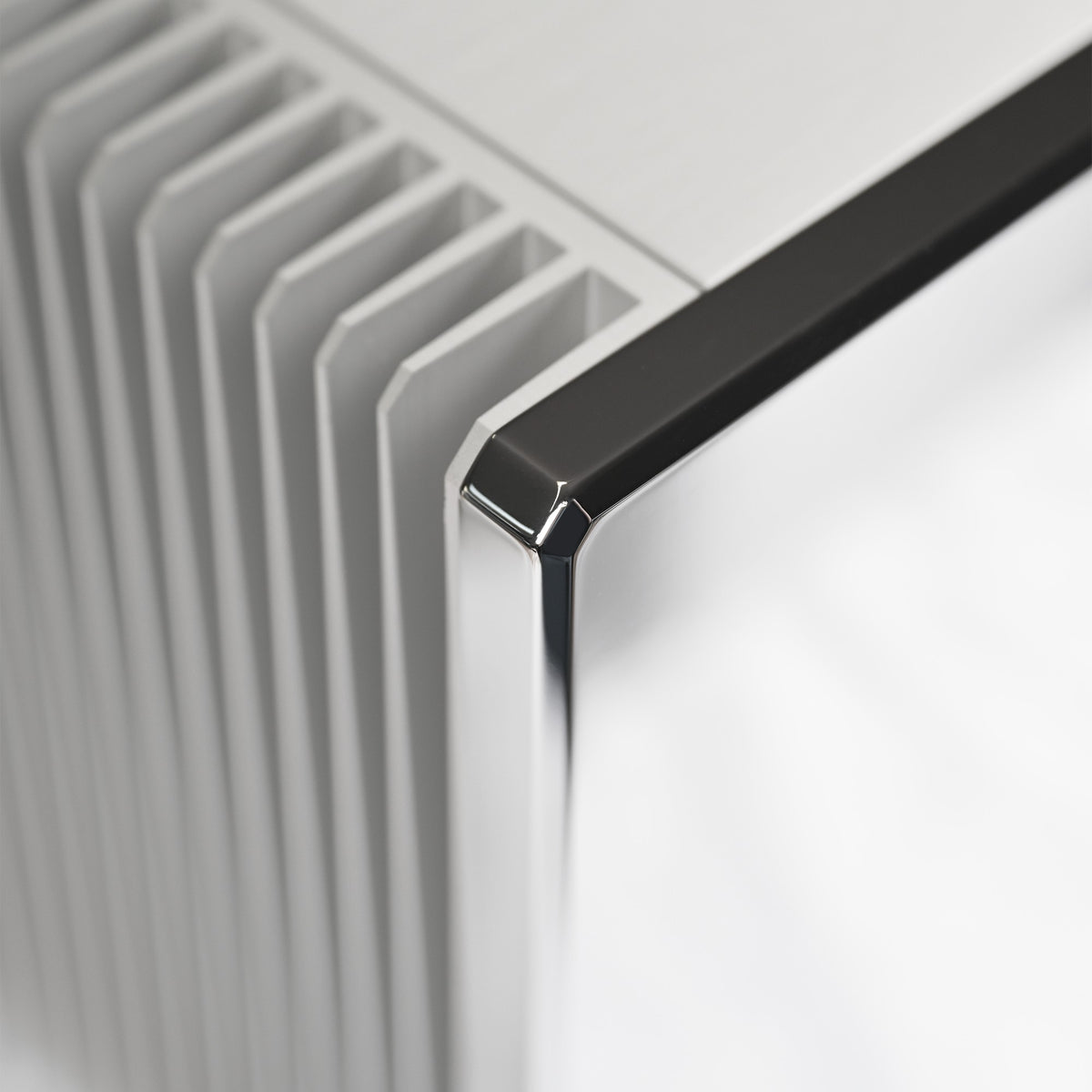 AVM Ovation SA 8.3 Lite Stereo Power Amplifier, Cellini chrome, heat sink fins and chrome front corner close-up