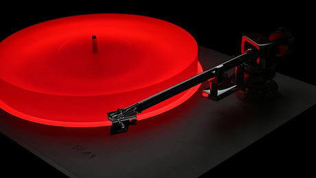 AVM Rotation R 5.3 MK2 Turntable, platter lit red with the tonearm in the dark