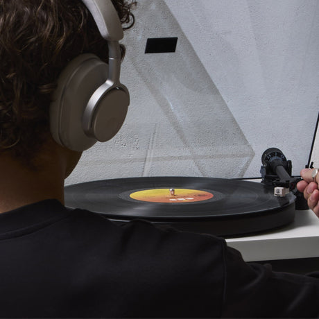 Cambridge Audio Spira Belt Drive Turntable, lifestyle, listening on headphones while cueing a record