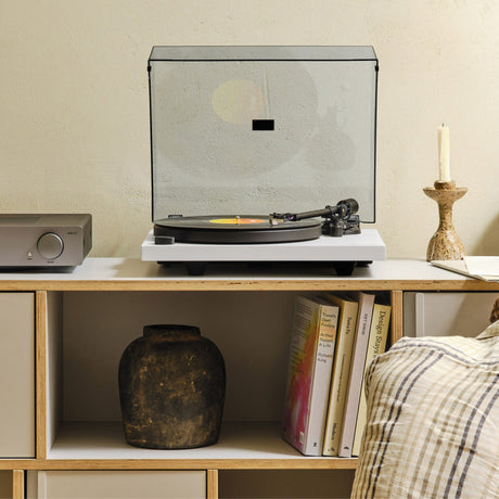 Cambridge Audio Spira Belt Drive Turntable, White, lifestyle, on a sideboard with the dust cover closed