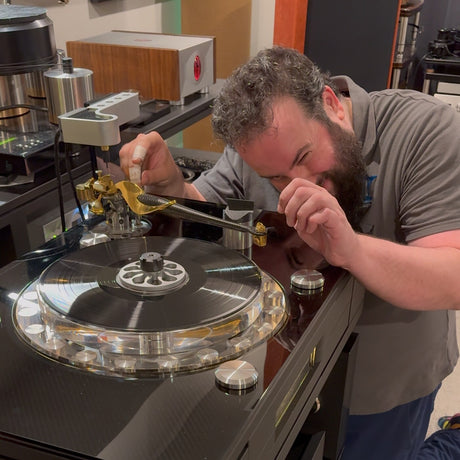 Phono cartridge mounting and alignment service, Mike at eye level checking cartridge alignment on a high-end turntable tonearm