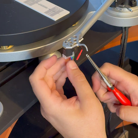 Phono cartridge mounting and alignment service, Mike wiring a cartridge on the headshell, alignment protractor on the platter