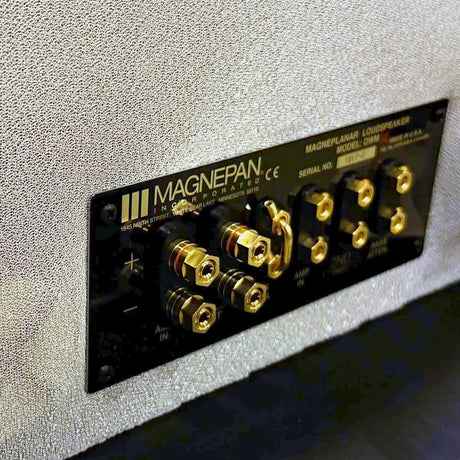 Magnepan DWMx Bass Panel, Off White, rear connection panel close-up showing the gold binding posts, amplifier input and bass attenuation terminals