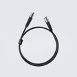 Matrix Audio Silver Copper Hi-Fi Clock Cable, Black, coiled three-quarter view on gray gradient