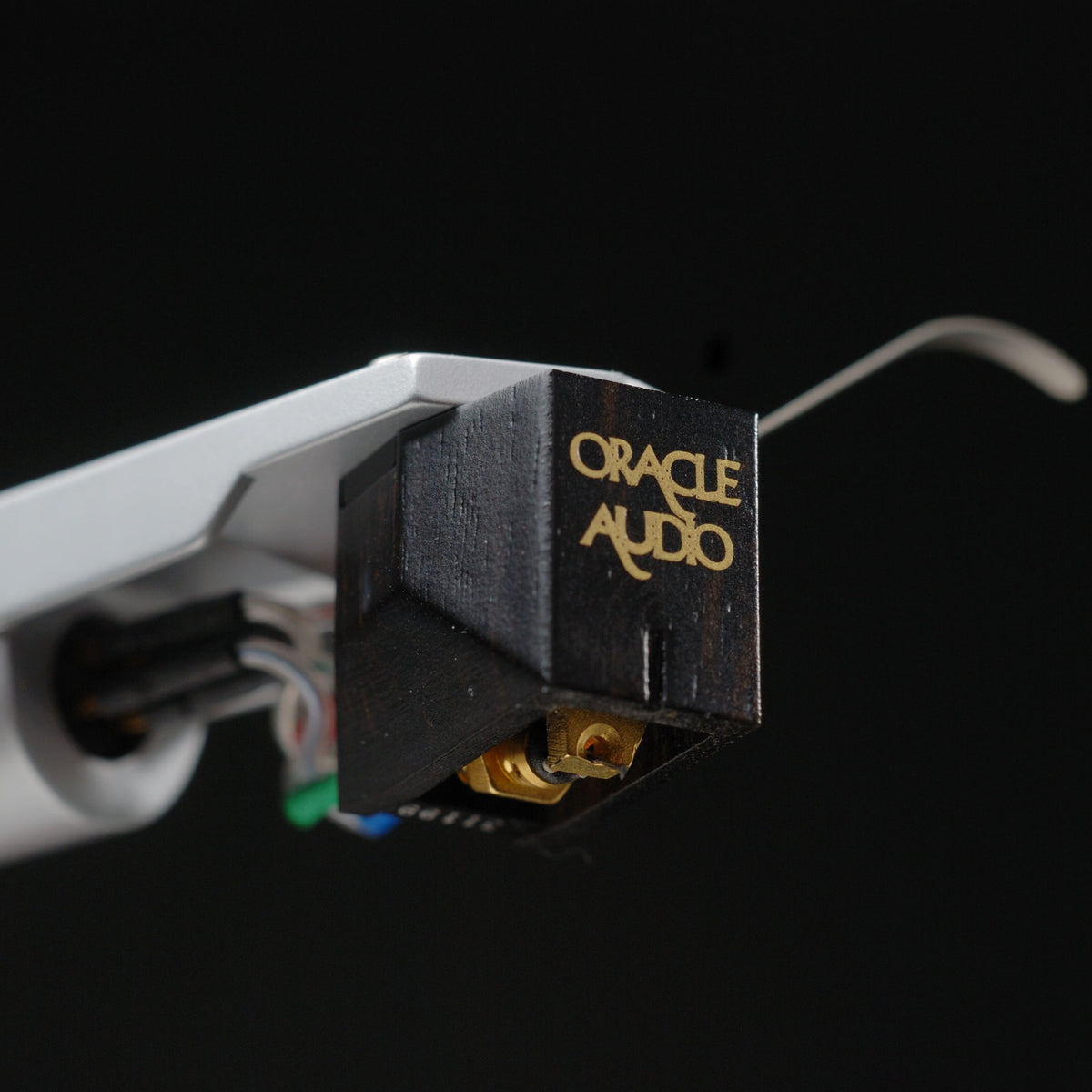 Oracle Audio Thalia Phono Cartridge, ebony, three-quarter view facing right on a tonearm against a black background