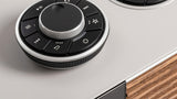 Ruark R810 RotoDial close-up showing weighted volume control, playback buttons, and preset favorites