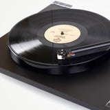 Rega Planar 1 Phenolic Resin Platter, Black, fitted to a matt black Planar 1 with a record, platter edge close-up