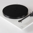Rega Planar 1 Phenolic Resin Platter, Black, fitted to a matt white Planar 1 with felt mat, three-quarter view