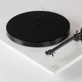 Rega Planar 1 Phenolic Resin Platter, Black, fitted to a matt white Planar 1 with felt mat, three-quarter view
