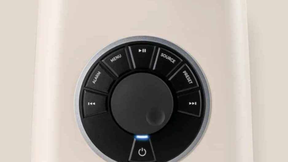 Ruark R1 MK4 RotoDial controller close-up showing source, menu, alarm, and preset controls