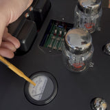 Mike demonstrating tube bias on a Rogue Audio Cronus Magnum integrated amplifier, bias tool on the DC milliampere meter beside the output tubes