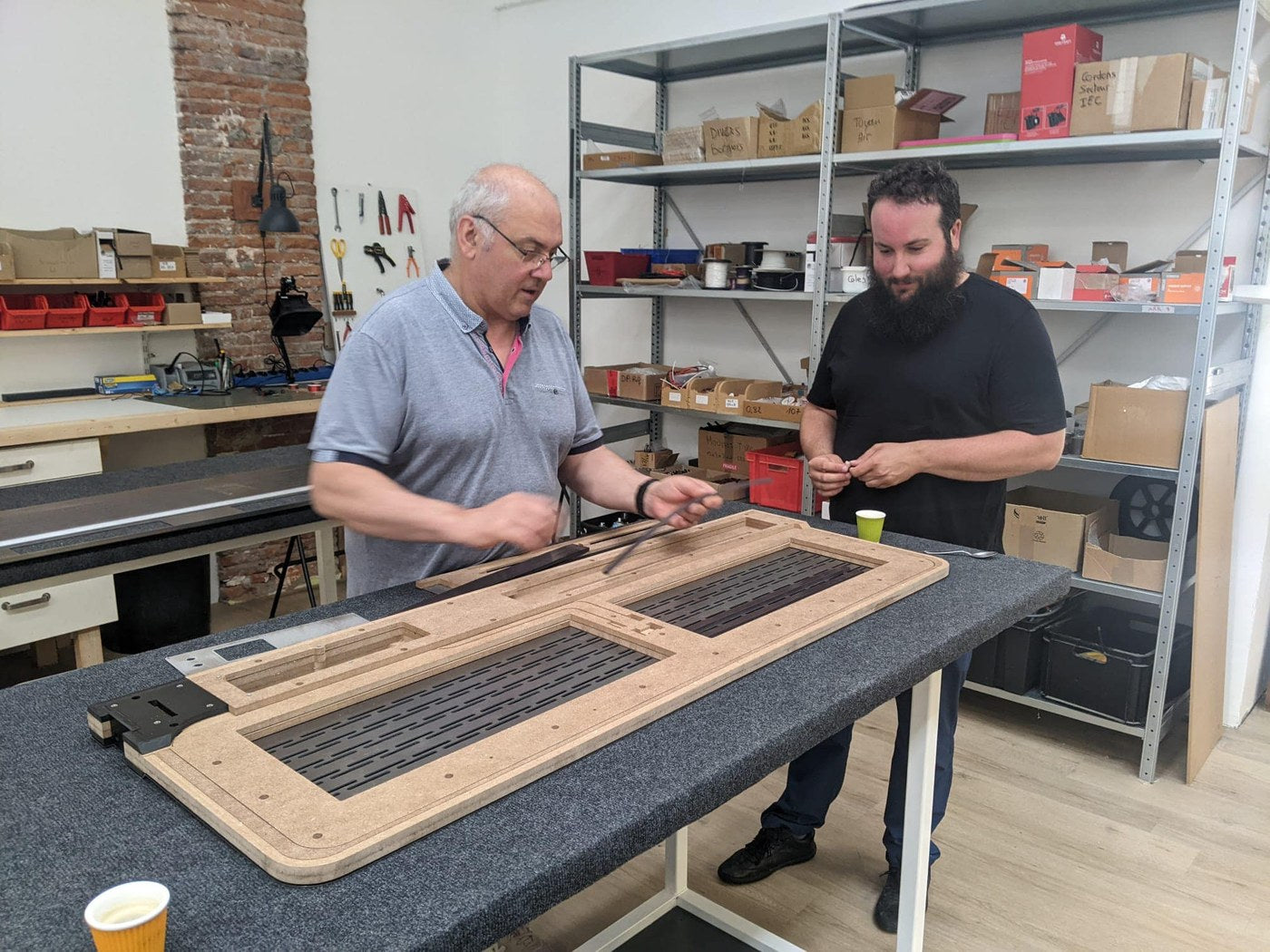Mike Hoatson at the Diptyque loudspeaker factory in 2023, watching a planar panel being assembled on the bench.